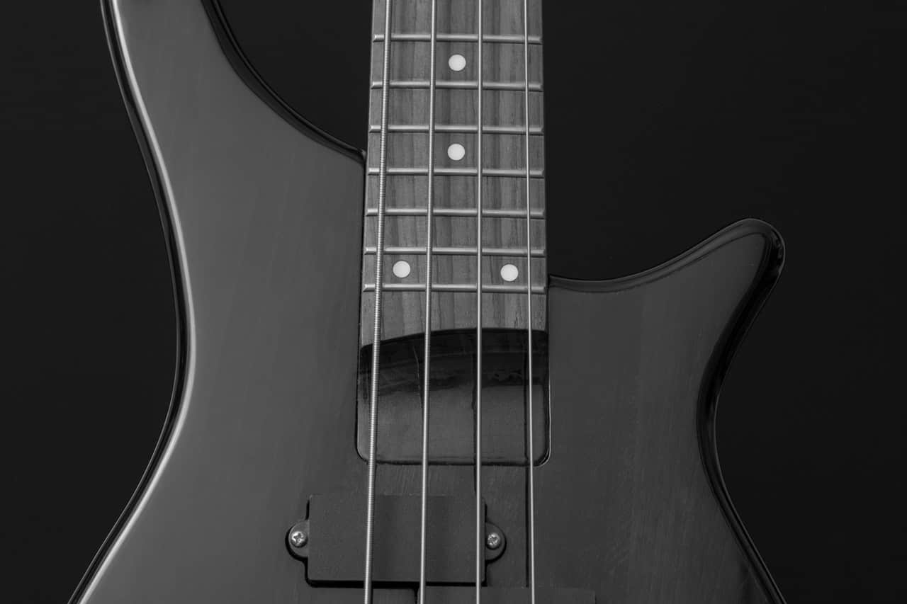 a black bass guitar with a black fretboard