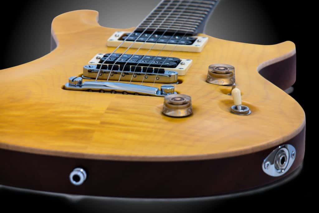 A close up of an electric guitar. Is electric guitar easier to play than acoustic?